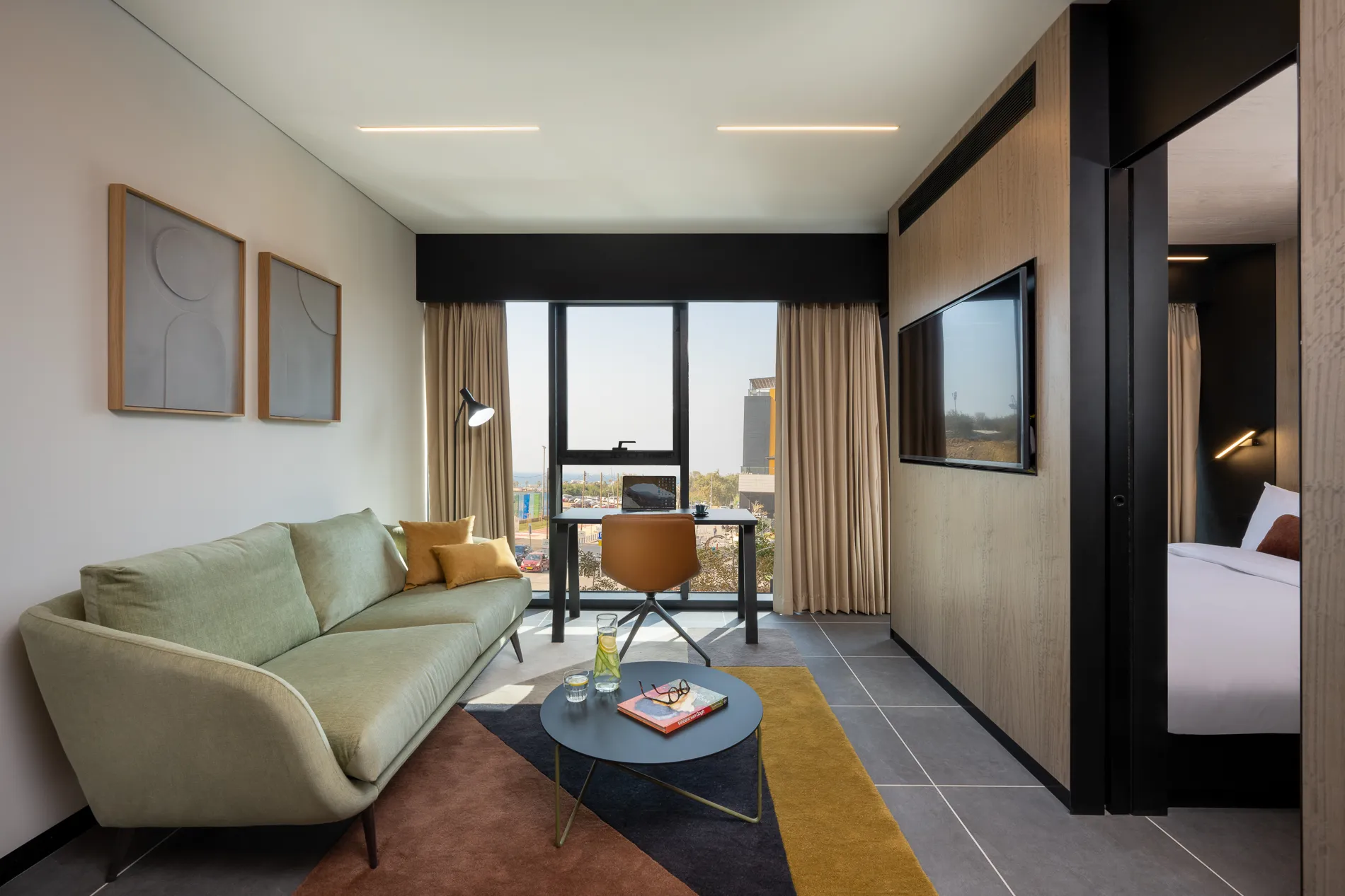 Bright and inviting living space in a master Bat Yam apartment, designed with a comfortable sofa and modern furnishings.