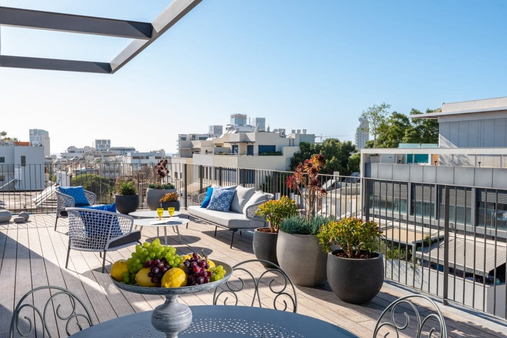 Spacious private terrace in a master Shenkin Tel Aviv apartment, offering a stylish outdoor seating area.