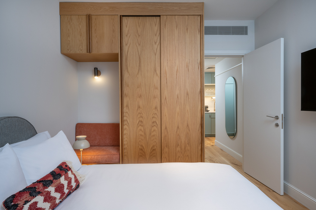 Bright and cozy sleeping area in the One-Bedroom with Sofa Bed at master Mazeh Tel Aviv, designed for relaxation with soft linens and elegant decor.