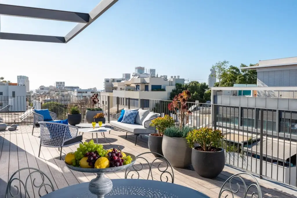 Spacious private terrace in a master Shenkin Tel Aviv apartment, offering a stylish outdoor seating area.