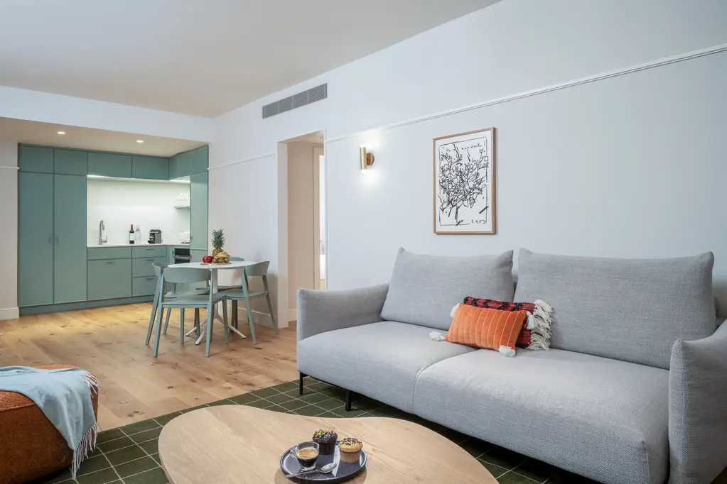 Well-designed open-plan living area in the Two-Bedroom with Sofa Bed at master Mazeh Tel Aviv, seamlessly connecting to the kitchen